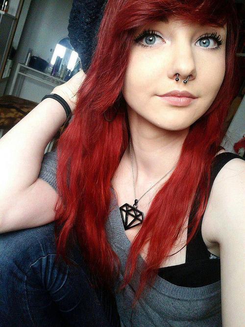 Scene girl with red hair and piercings full size