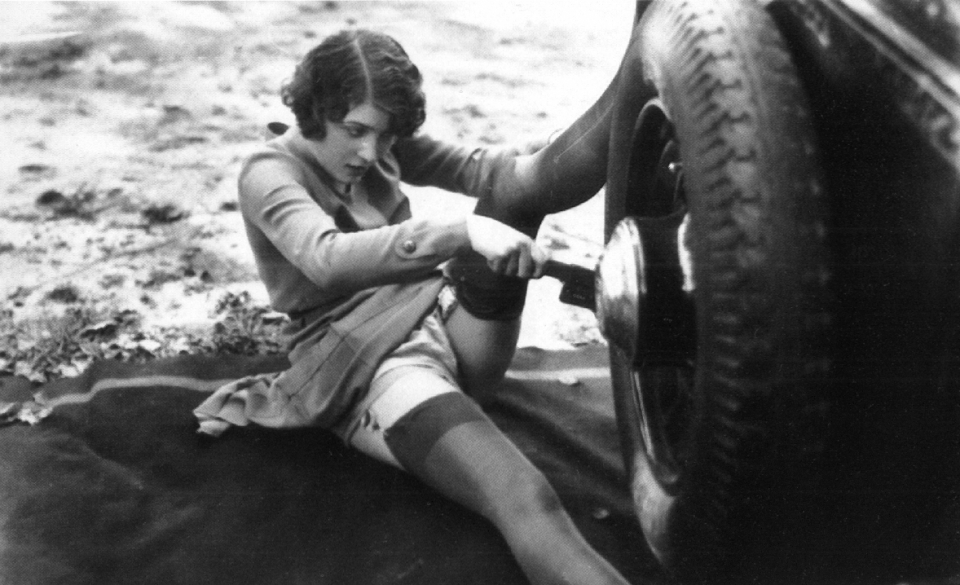 Vintage sexy woman fixing car full size