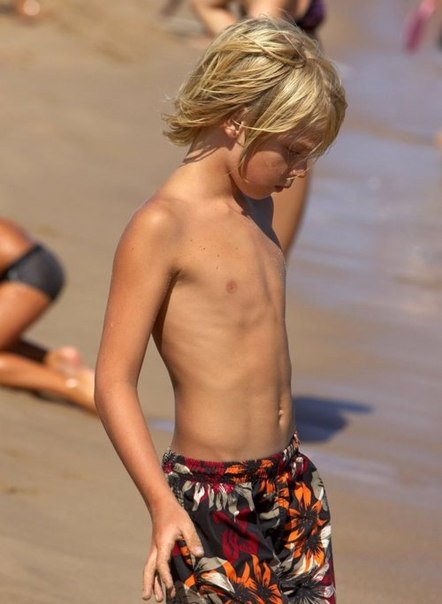 Cute blonde shirtless boys at the beach full size